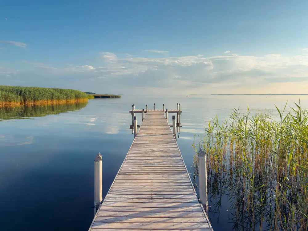 Wooden pier over cold lake water